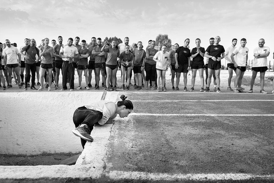 A runner starting a trial in front of a group of people.